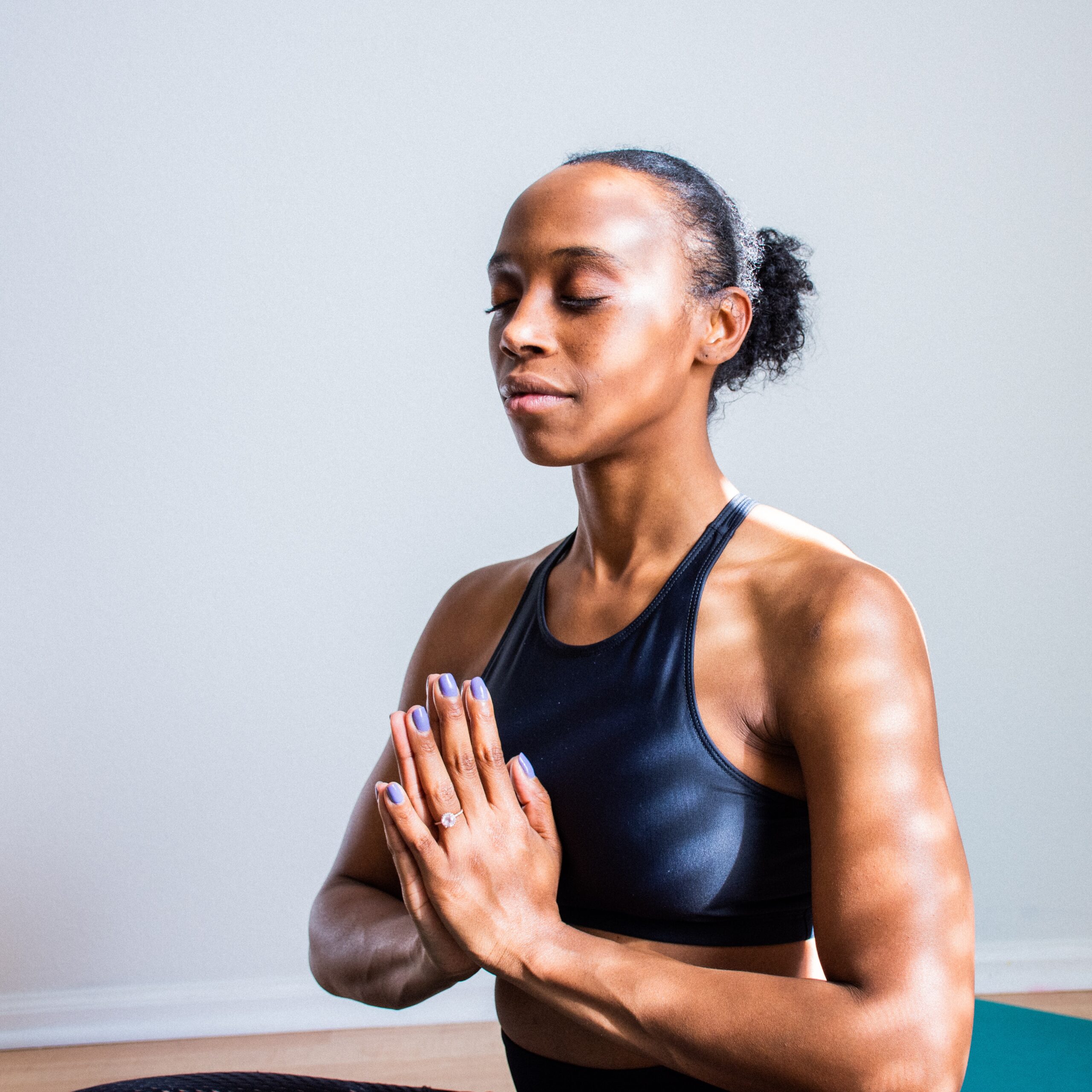 A woman closes her eyes while meditating with her hands together. Learn how to overcome anxiety symptoms in Brooklyn, NY with the support of therapy in Brooklyn, NY. Search for anxiety treatment in Brooklyn, NY and other services today.