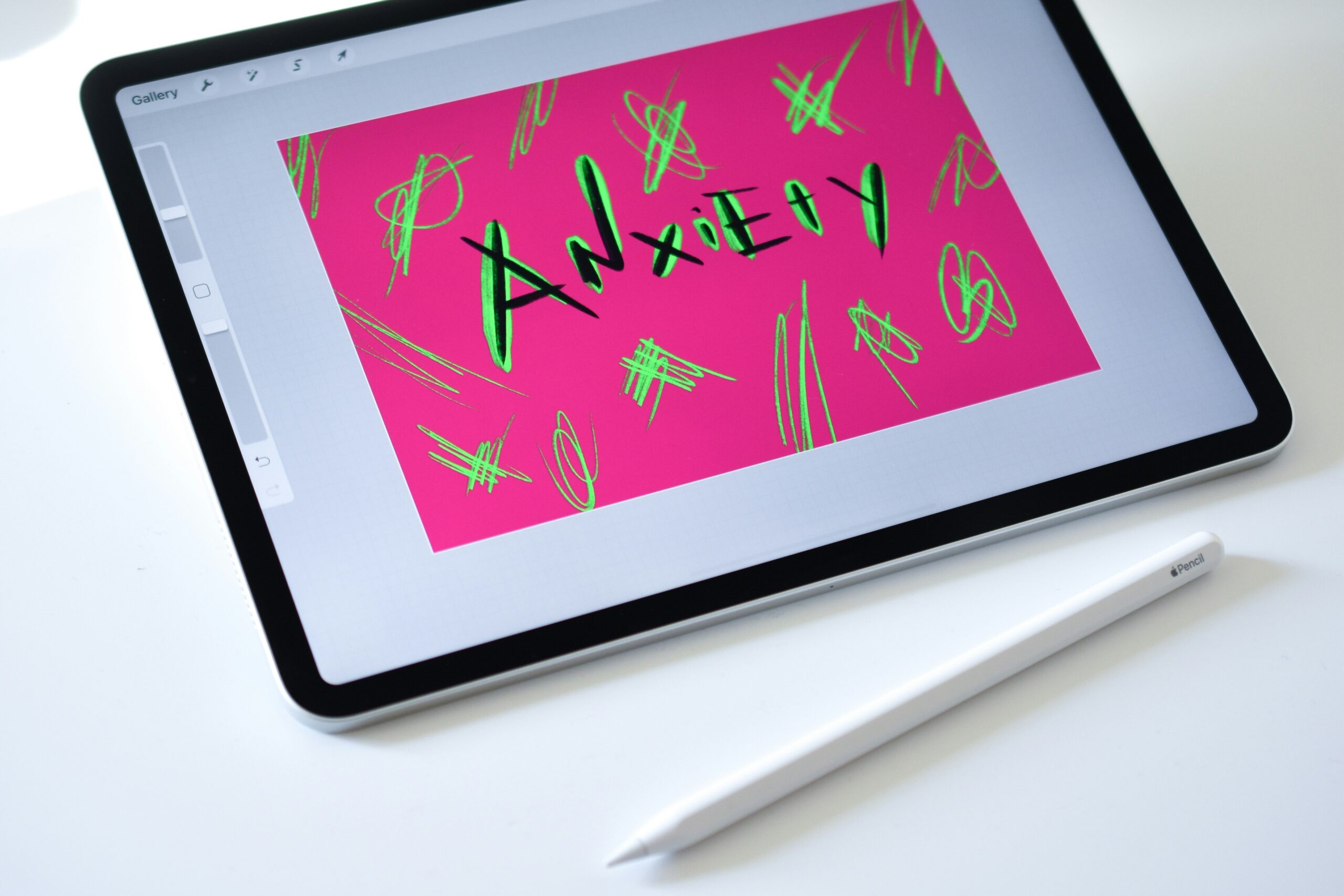 A digital drawing of the word 'Anxiety' on a tablet with neon scribbles, capturing the internal chaos of anxiety symptoms in Brooklyn, NY and promoting anxiety treatment in Brooklyn, NY led by culturally responsive therapists.