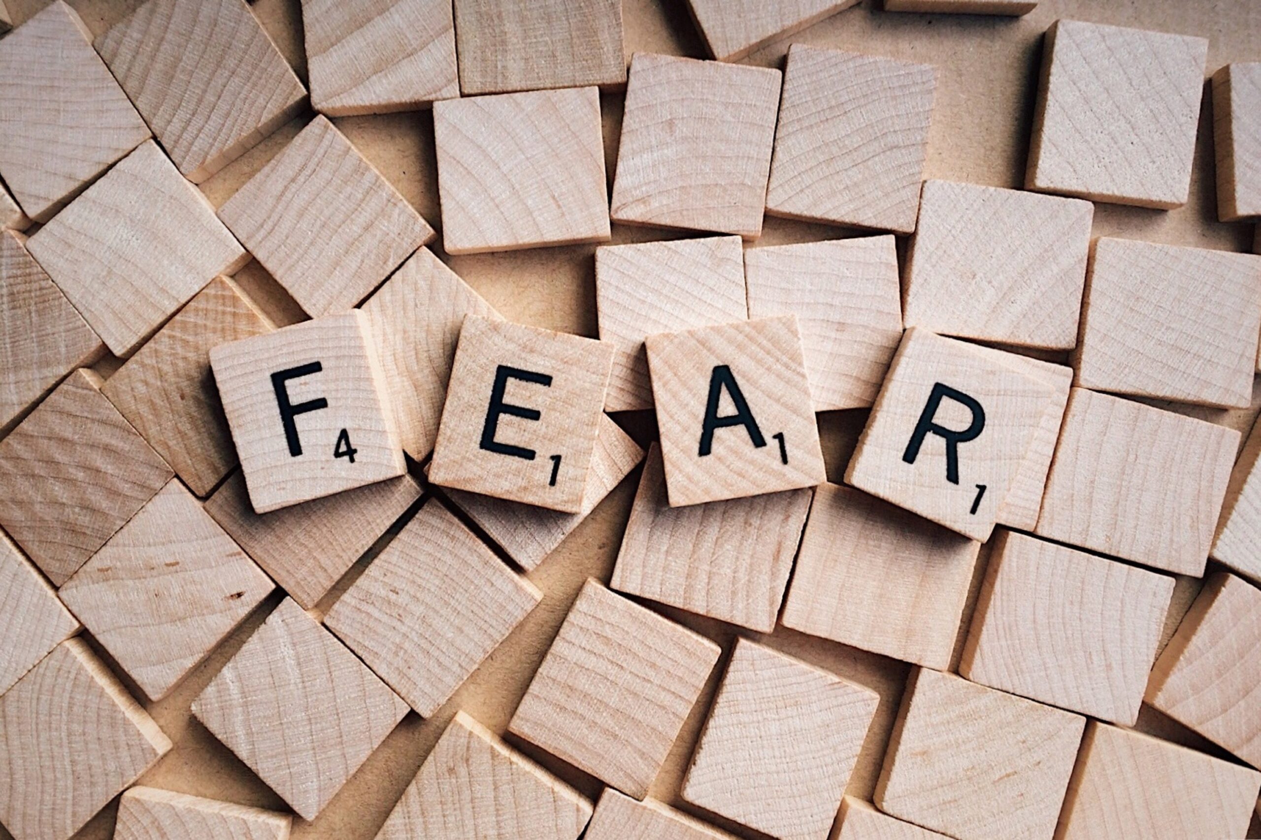 Scrabble letters arranged to spell the word fear, representing the overwhelming anxiety symptoms in Brooklyn, NY. Working with an anxiety therapist in Brooklyn, NY provides tools for fear of failure in Brooklyn, NY and helps through therapy for anxiety in Brooklyn, NY.