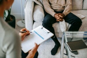 A therapist in Brooklyn, NY takes notes during a counseling session, offering compassionate therapy for depression in Brooklyn, NY as part of personalized depression treatment in Brooklyn, NY.